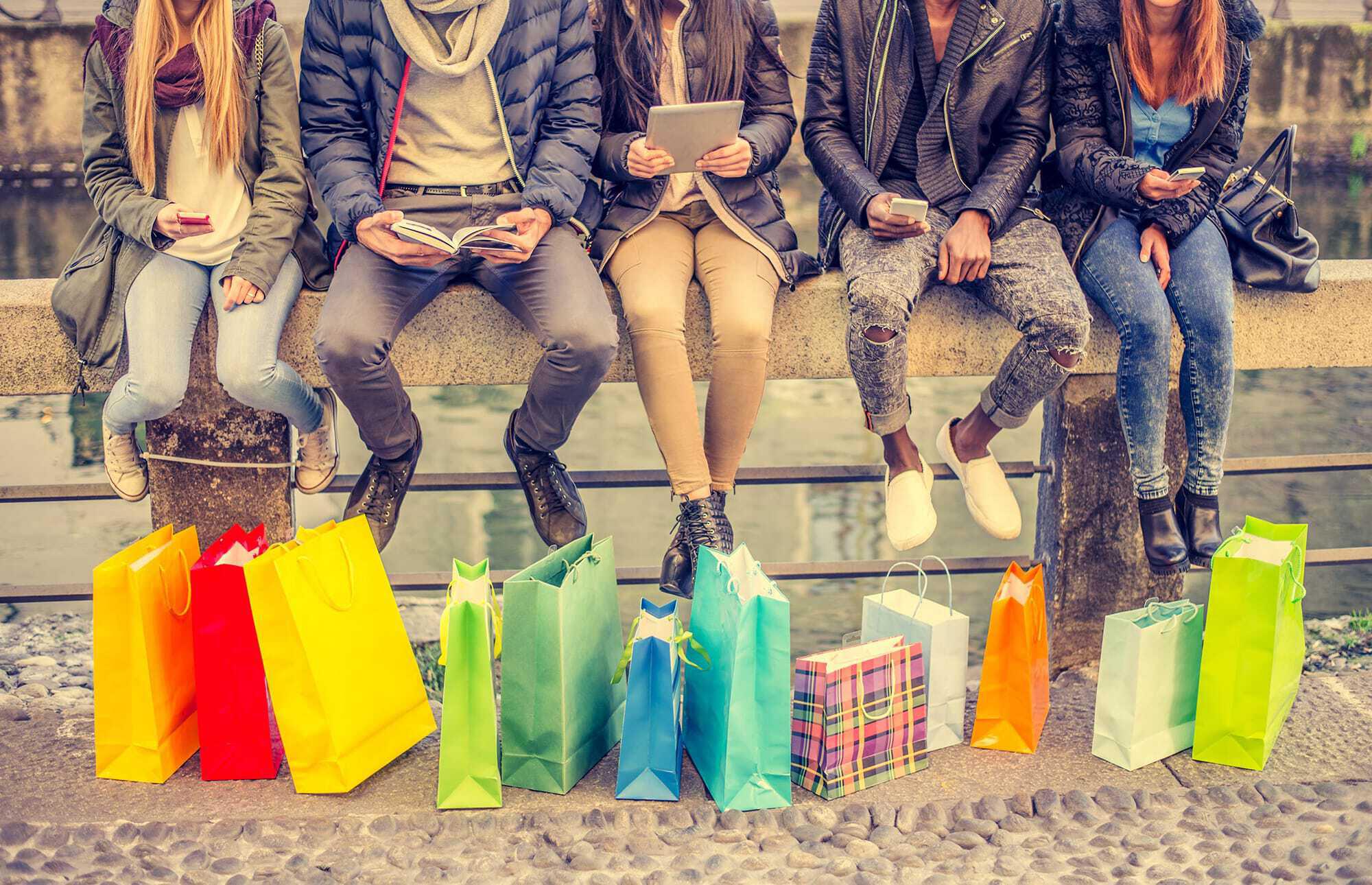 group of people with colorful shopping bags