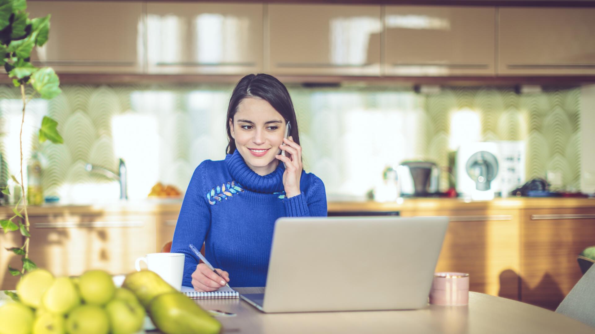 woman wearing blue shirt on computer