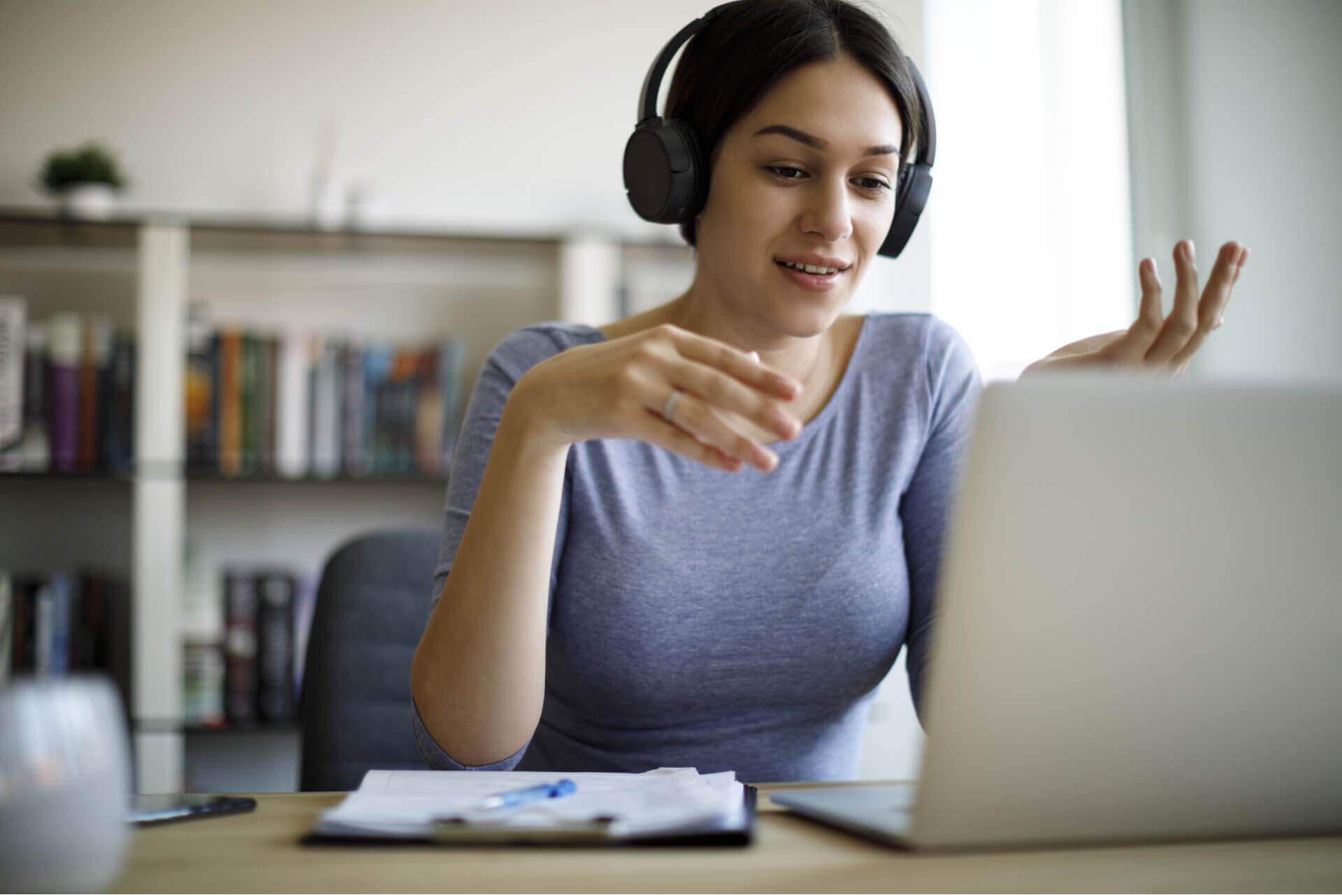 woman wearing headset on computer